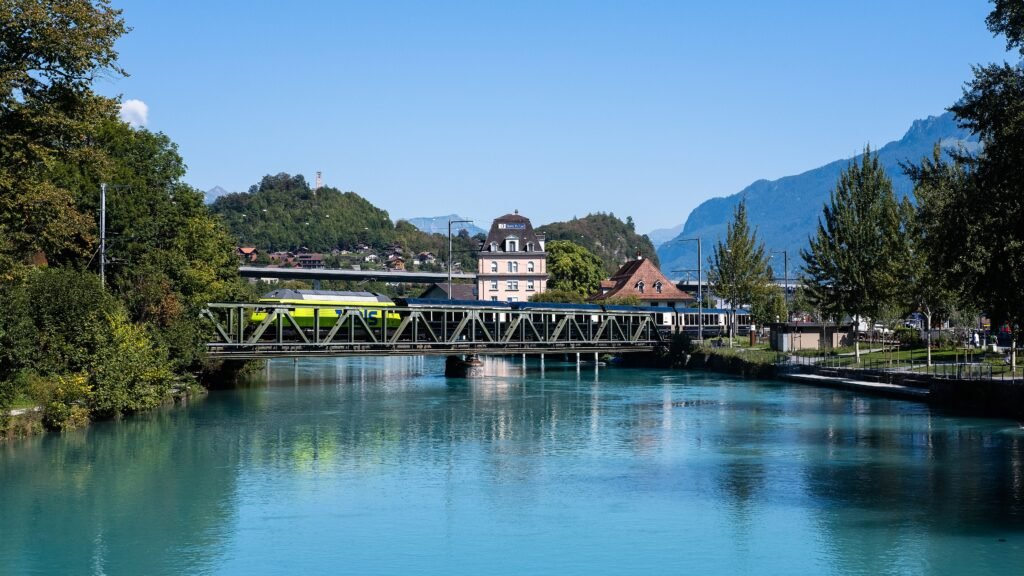 The Aare river beside Interlaken Ost with a bridge and railway infrastructure