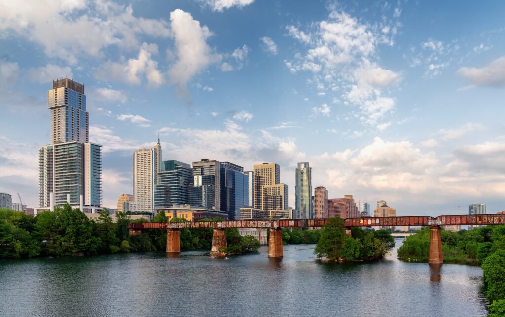 Austin skyline seen across Lady Bird Lake from a pedestrian bridge