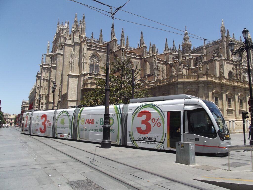 Pedestrianized Avenida de la Constitución beside Seville Cathedral with a MetroCentro tram