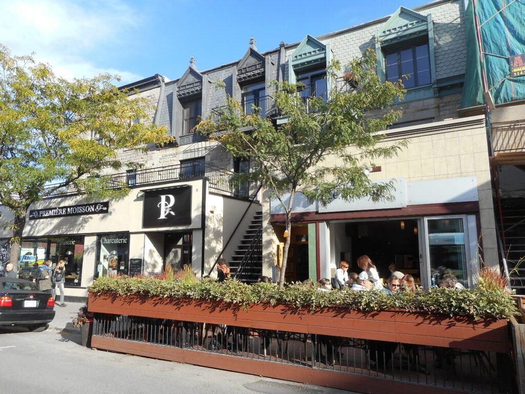 Avenue du Mont-Royal streetscape with shops, terraces and pedestrians in Montréal