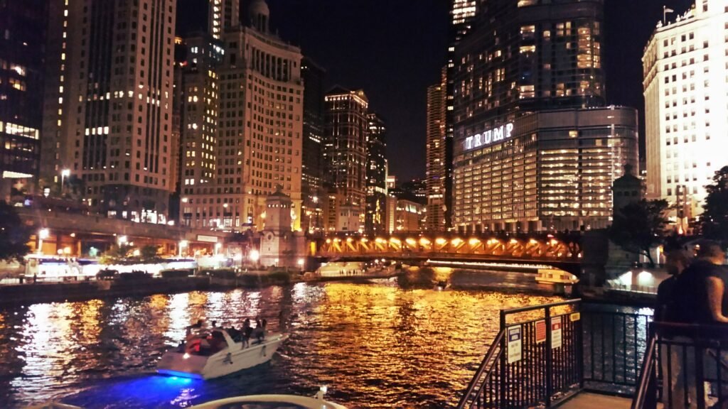 Chicago River surrounded by downtown buildings at night