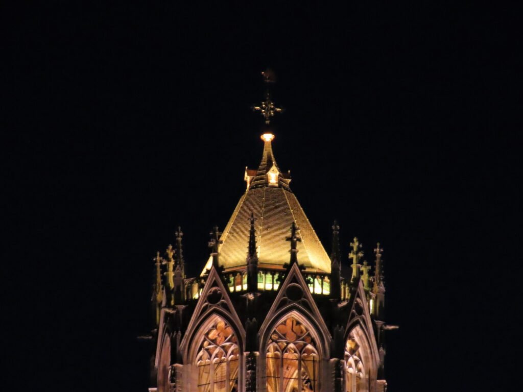 Illuminated upper section of Utrecht Dom Tower at night