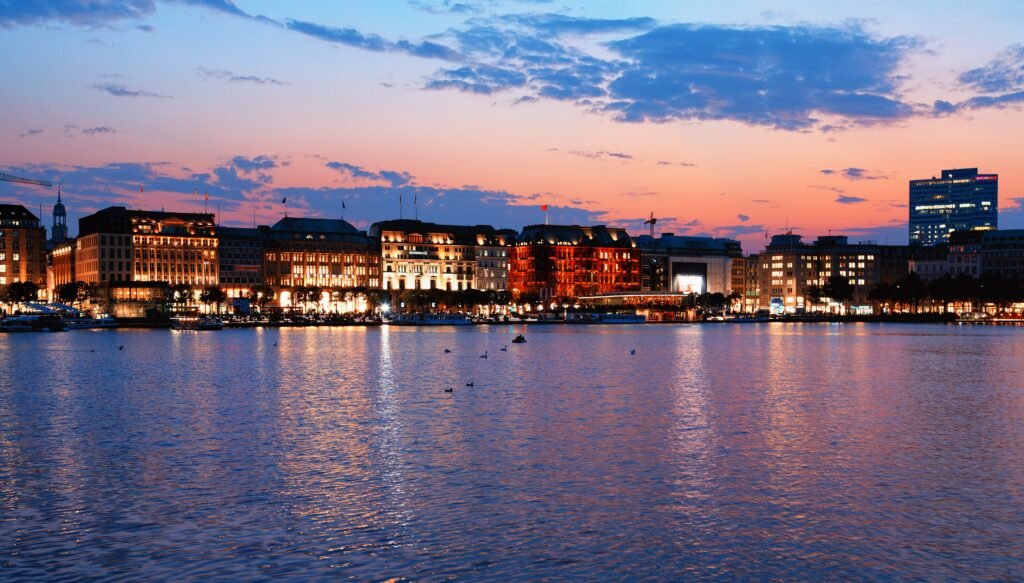 Hamburg skyline reflected across the Binnenalster at sunset
