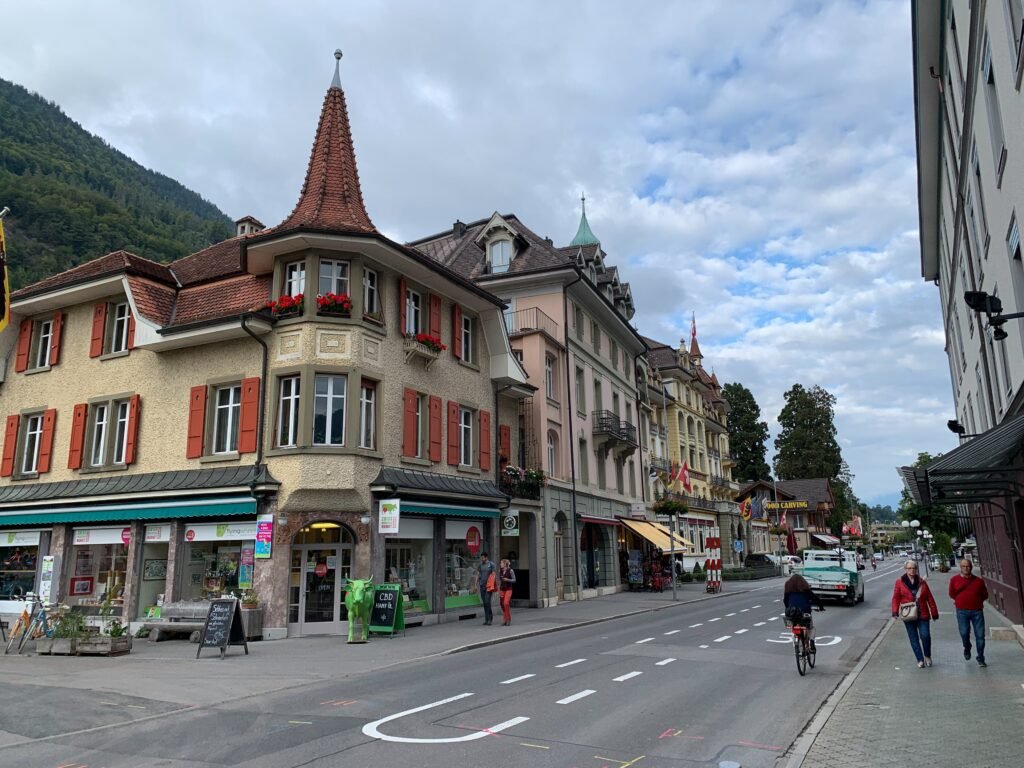Höheweg street in central Interlaken with shops, pedestrians and mountain slopes