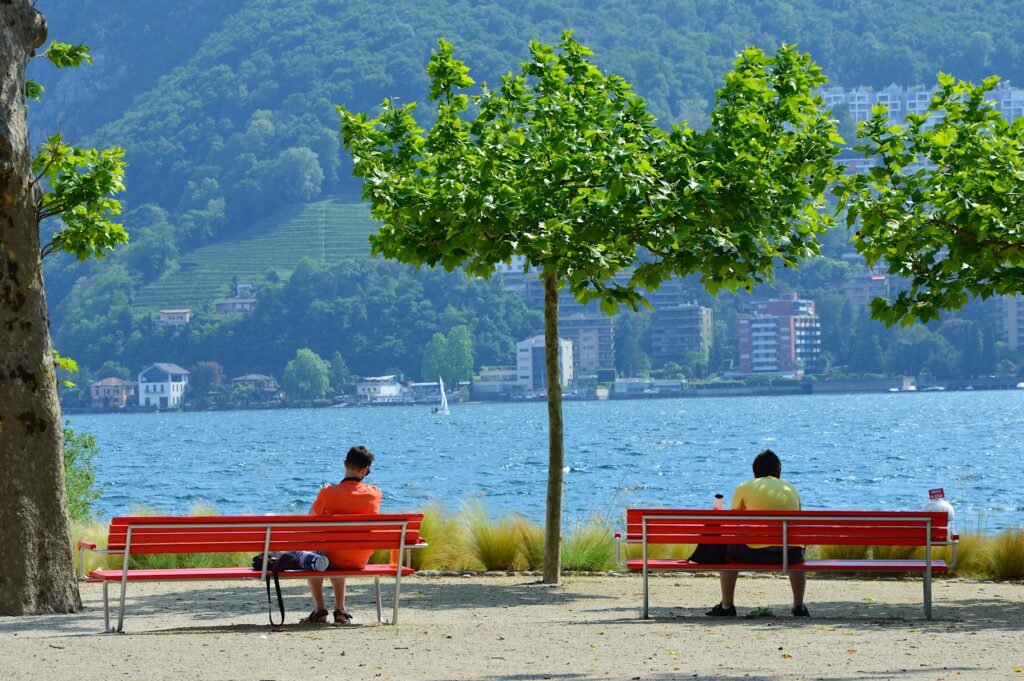 Lake Lugano waterfront seen from Parco Ciani with benches and plane trees