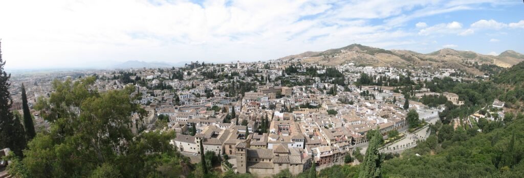 Wide panorama of Granada's Albaicín and Sacromonte hillside neighborhoods from the Alhambra