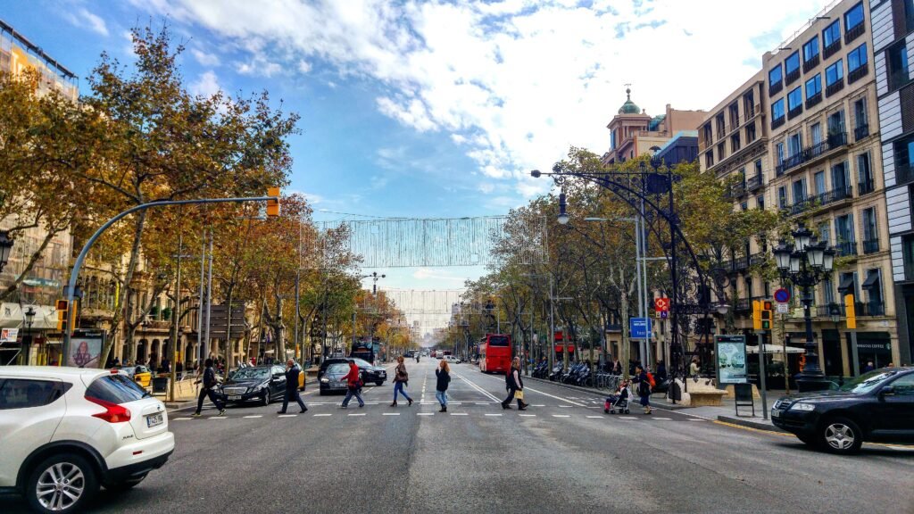 Passeig de Gràcia boulevard with broad sidewalks and a pedestrian crossing in Barcelona