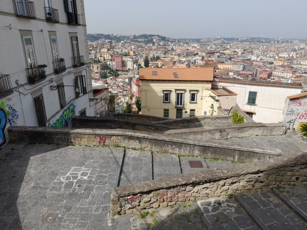 Steep stone Pedamentina stair route descending above central Naples
