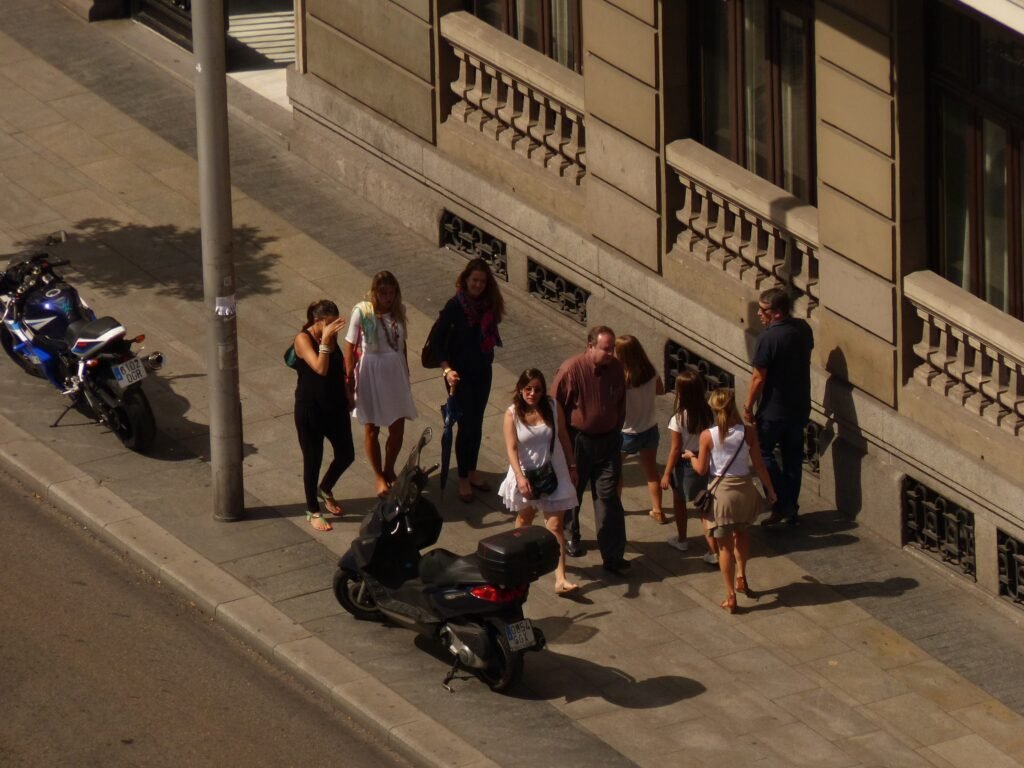 Pedestrians walking along a central Madrid street near Gran Vía