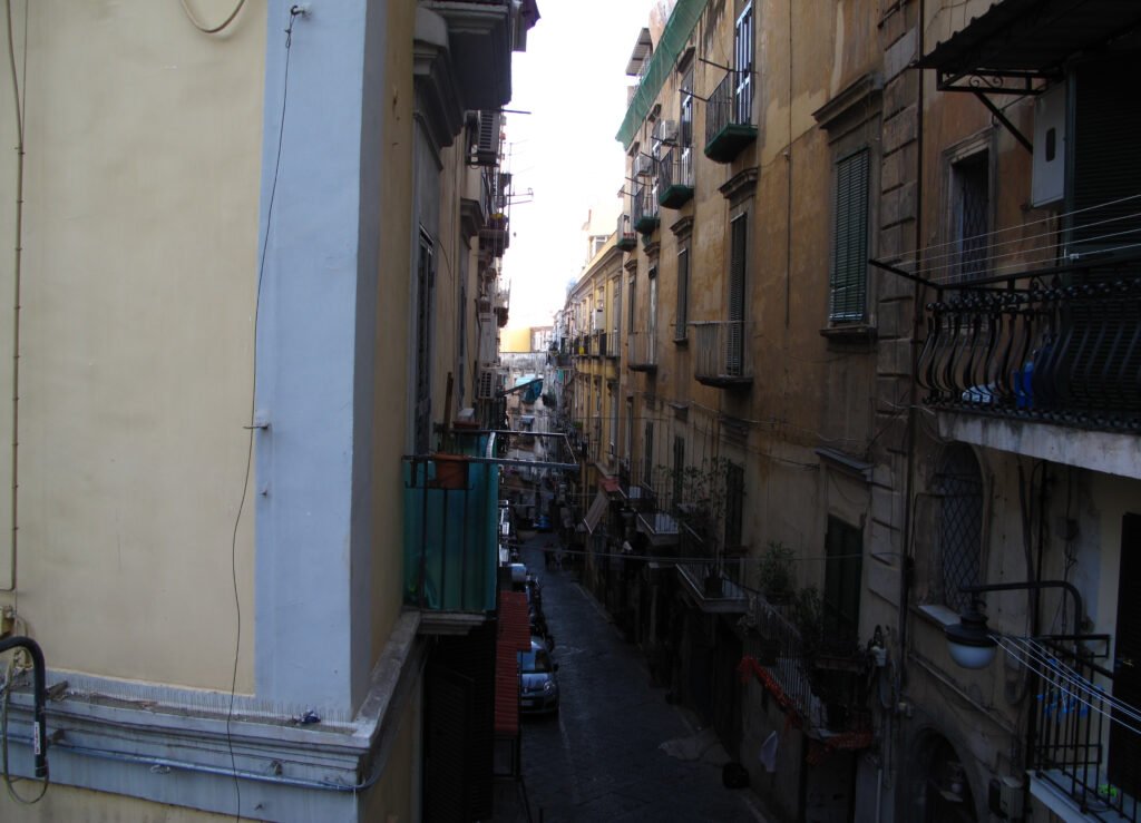 Narrow alley in Naples' Spanish Quarter climbing between residential buildings