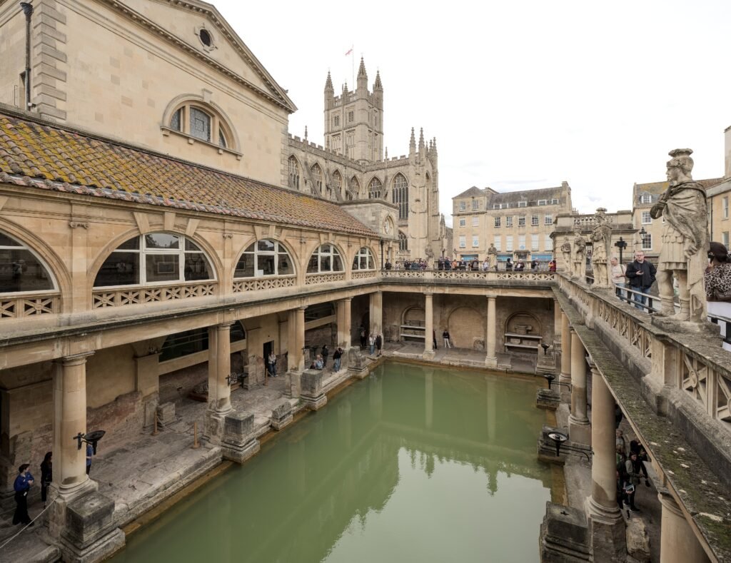 The Great Bath at the Roman Baths with Bath Abbey in the background
