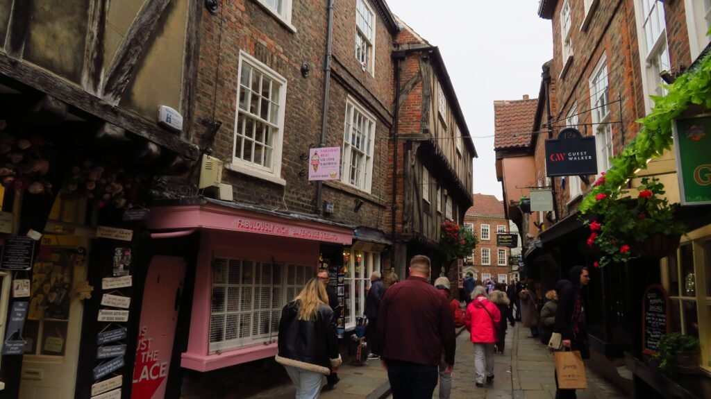 Pedestrians walking through the narrow historic Shambles in York