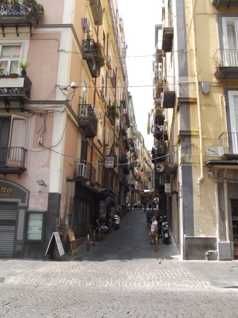 Steep side street rising from Via Toledo in Naples