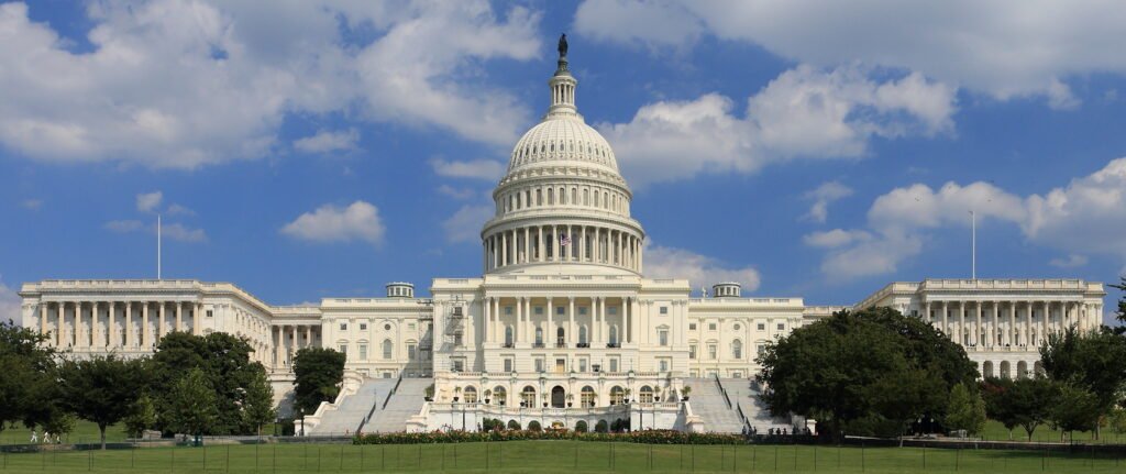 West front of the United States Capitol under a blue sky