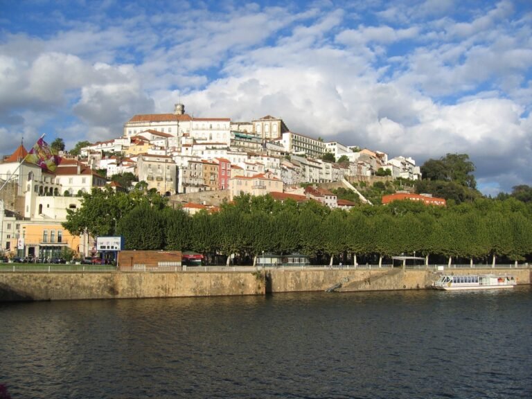 Coimbra old town rising above the Mondego River from Santa Clara Bridge