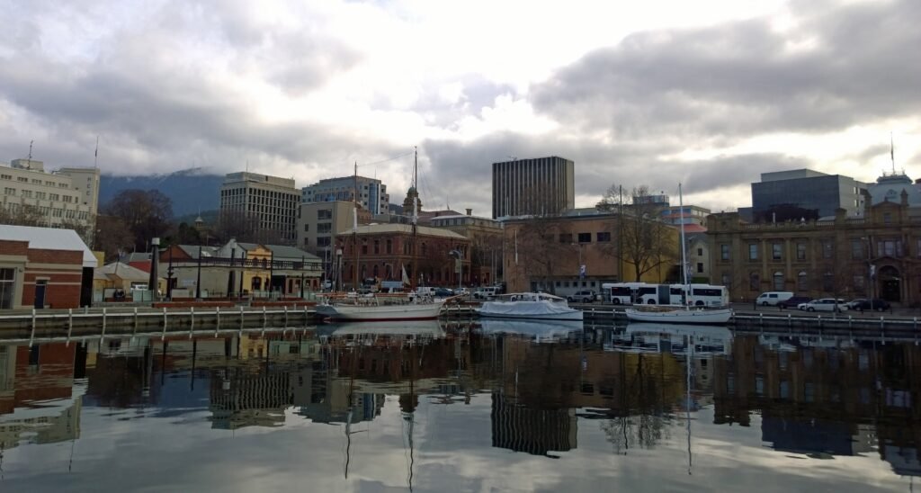 Constitution Dock in Hobart with the CBD and Tasmanian Museum and Art Gallery beyond