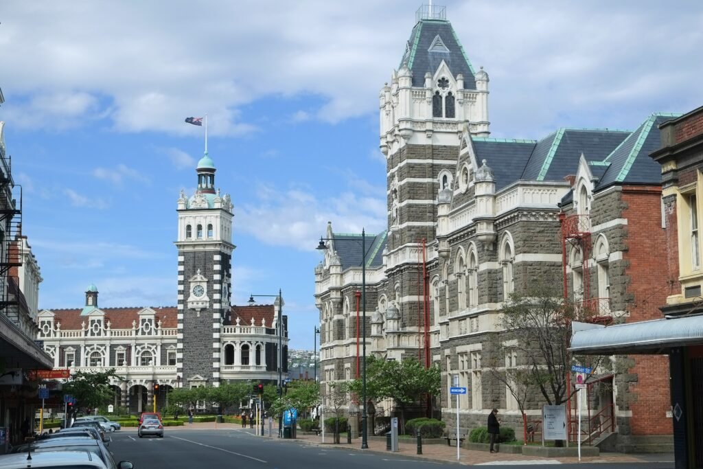 Dunedin Railway Station and nearby Law Courts beside central city streets