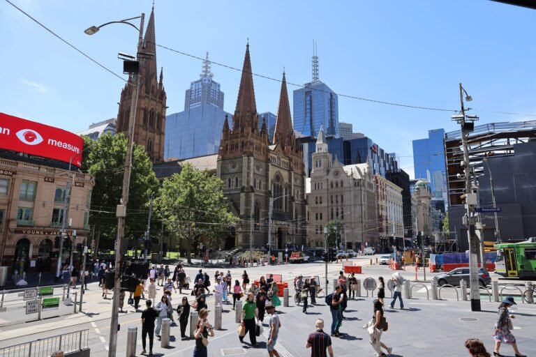 Pedestrians, tram tracks and St Paul’s Cathedral beside Federation Square in central Melbourne