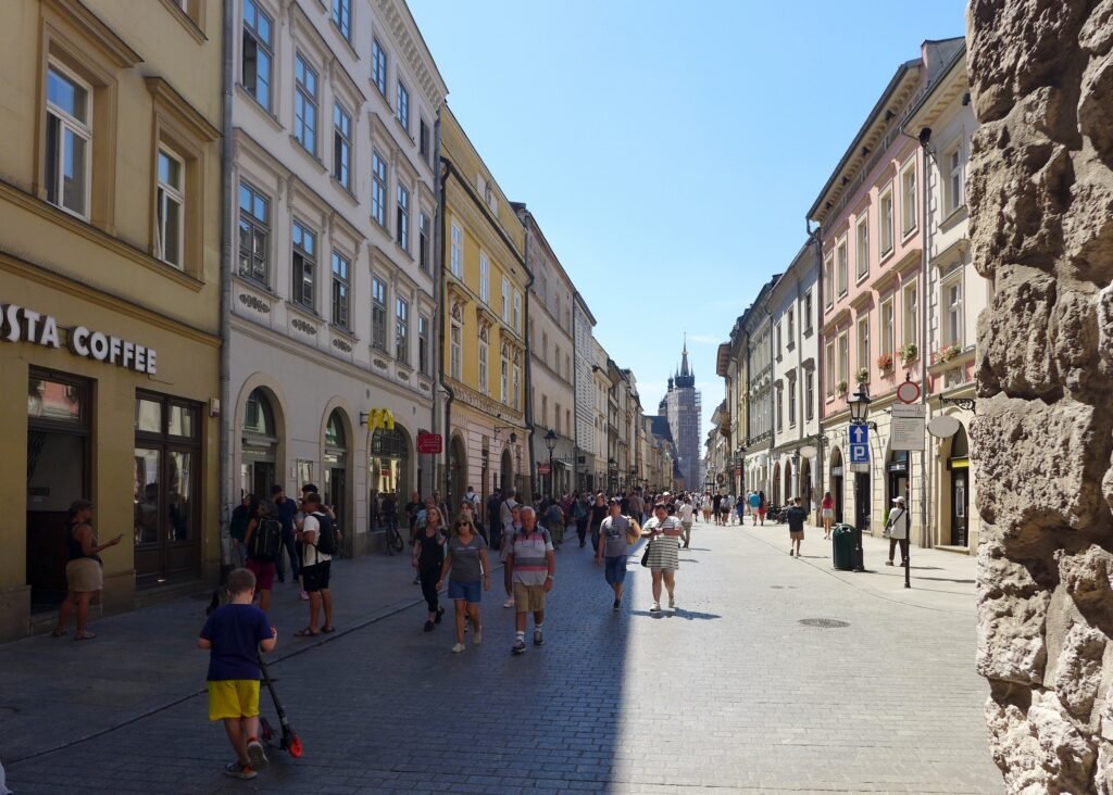 Pedestrians walking along Floriańska Street in Kraków Old Town