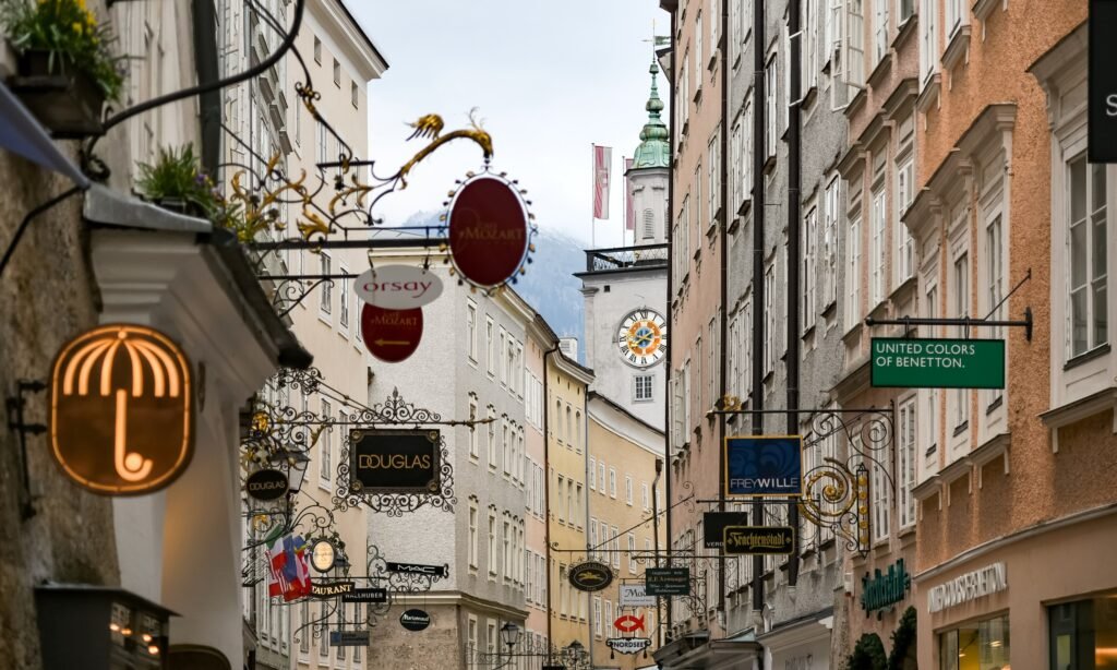 Getreidegasse in Salzburg with narrow historic buildings and hanging shop signs
