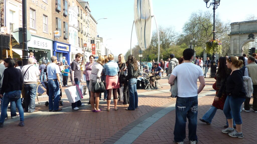 Pedestrians walking along Grafton Street in central Dublin