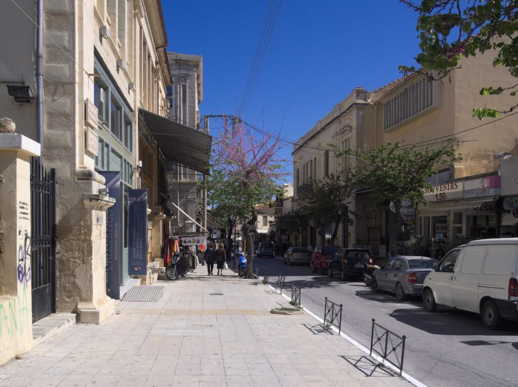 Halidon Street in central Chania with sidewalks, shops and the Old Town approach