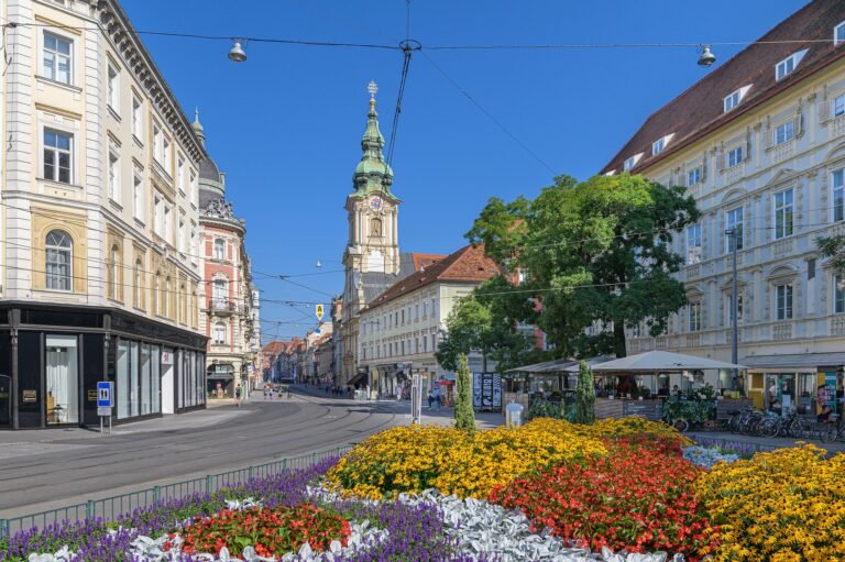 Herrengasse streetscape in central Graz with pedestrians and tram tracks
