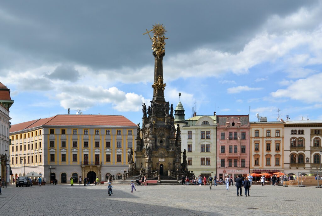People crossing the stone-paved Horní náměstí in Olomouc
