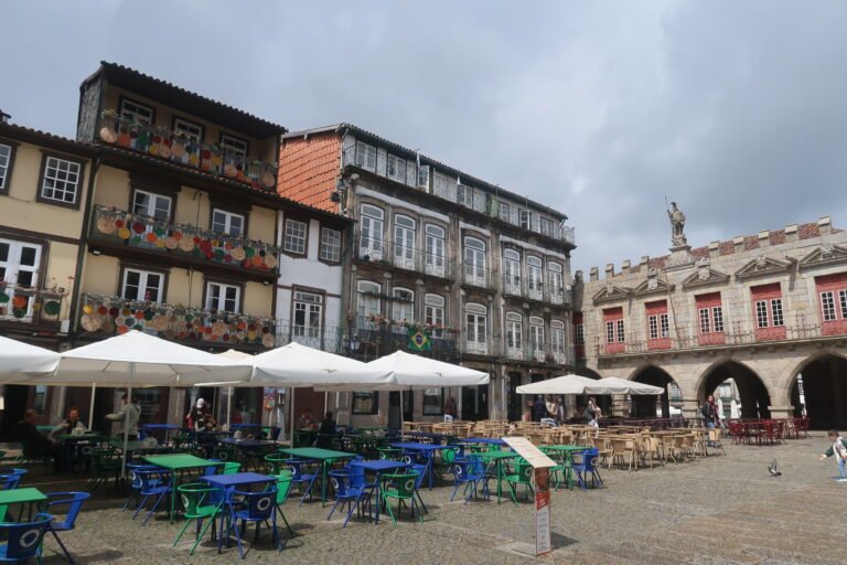 Largo da Oliveira in Guimarães with outdoor seating, historic buildings and stone paving