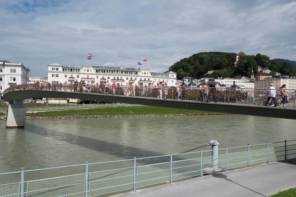 Pedestrians crossing Makartsteg over the Salzach in Salzburg