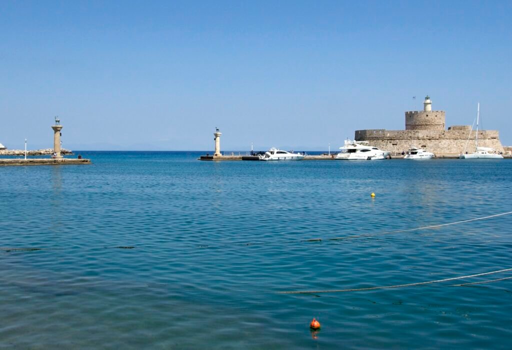Mandraki Harbor entrance and waterfront in Rhodes Town