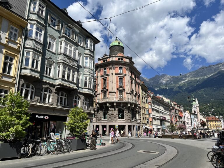 Pedestrians and buildings along Maria-Theresien-Straße in Innsbruck with the Nordkette behind