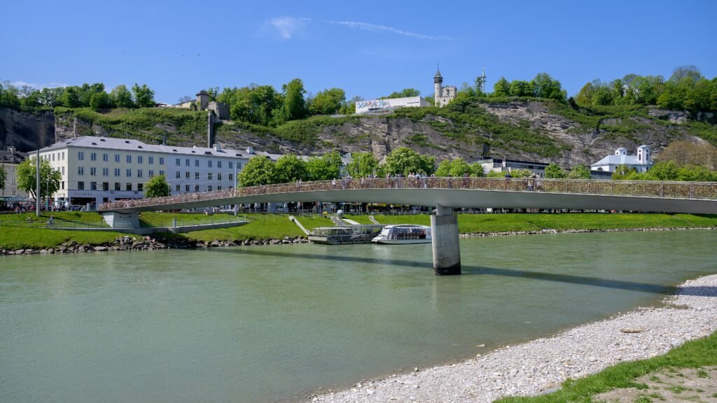 Marko-Feingold-Steg pedestrian bridge across the Salzach in Salzburg with Mönchsberg behind