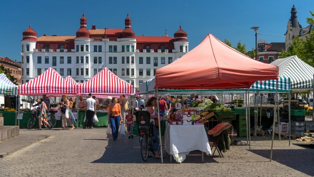 Market stalls and pedestrians at Möllevångstorget in Malmö