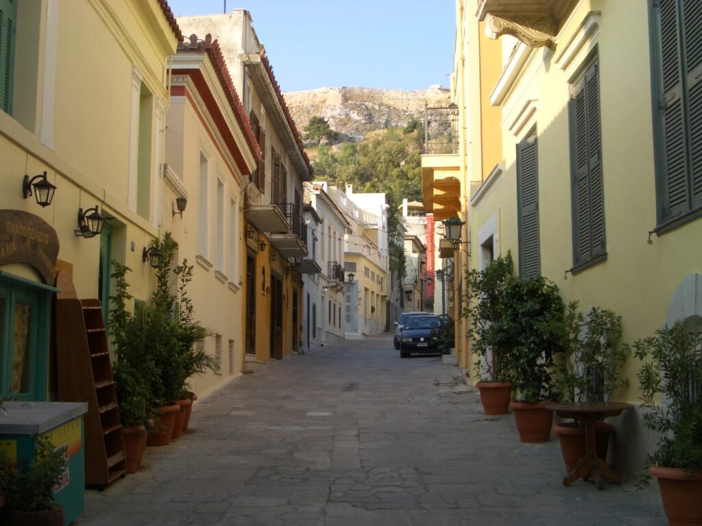 Narrow paved street in Plaka beneath the Acropolis in Athens