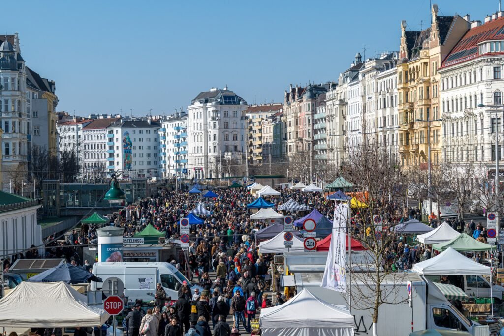 Visitors walking among stalls at Vienna's Naschmarkt