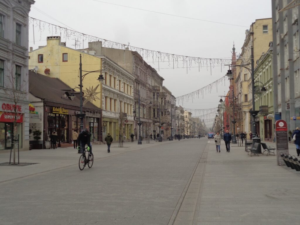 Pedestrians on the broad, flat Piotrkowska Street in Łódź