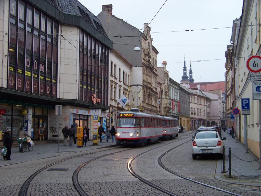 Pekařská street in central Olomouc with pedestrians, tram tracks and a tram at U Sv. Mořice