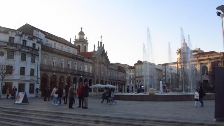 Pedestrians around the fountain at Praça da República in central Braga