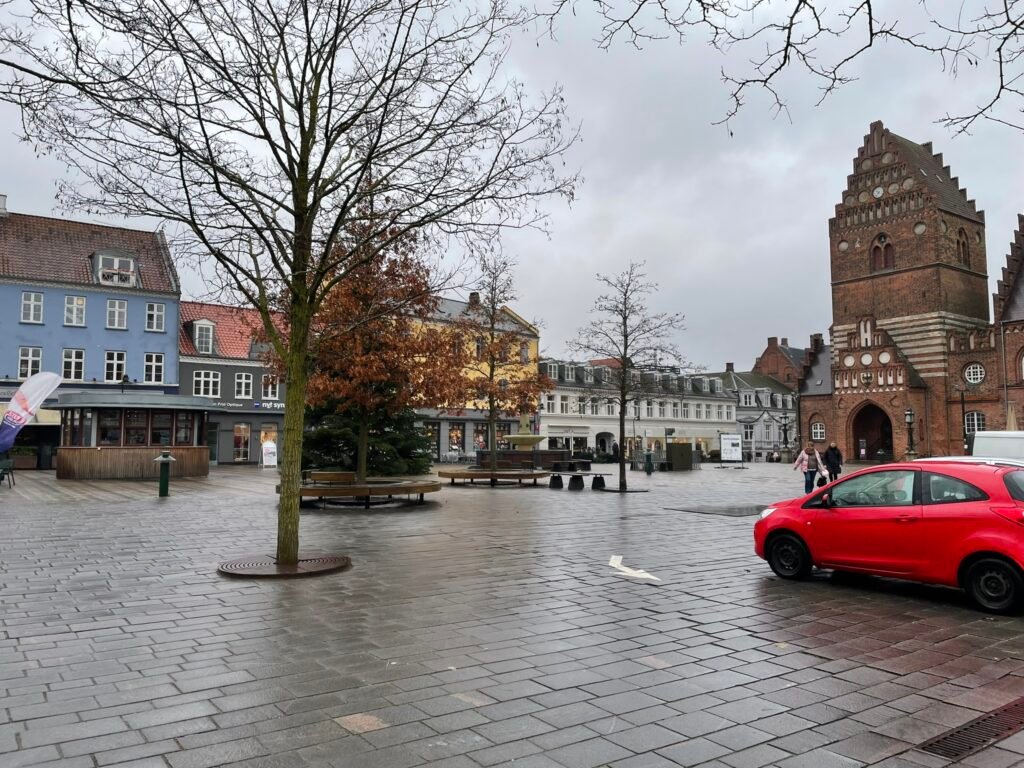 Stændertorvet square in central Roskilde with broad granite paving and surrounding historic buildings