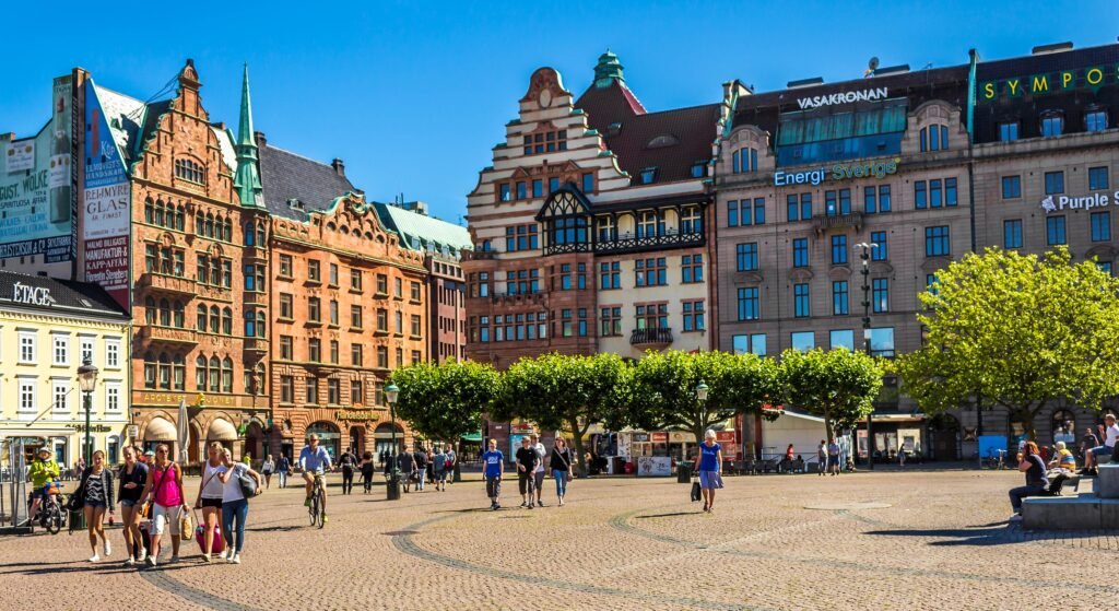 Pedestrians crossing Stortorget in central Malmö