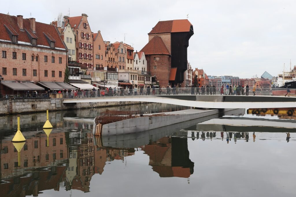 Pedestrians crossing the Św. Ducha footbridge between Main Town and Granary Island in Gdańsk