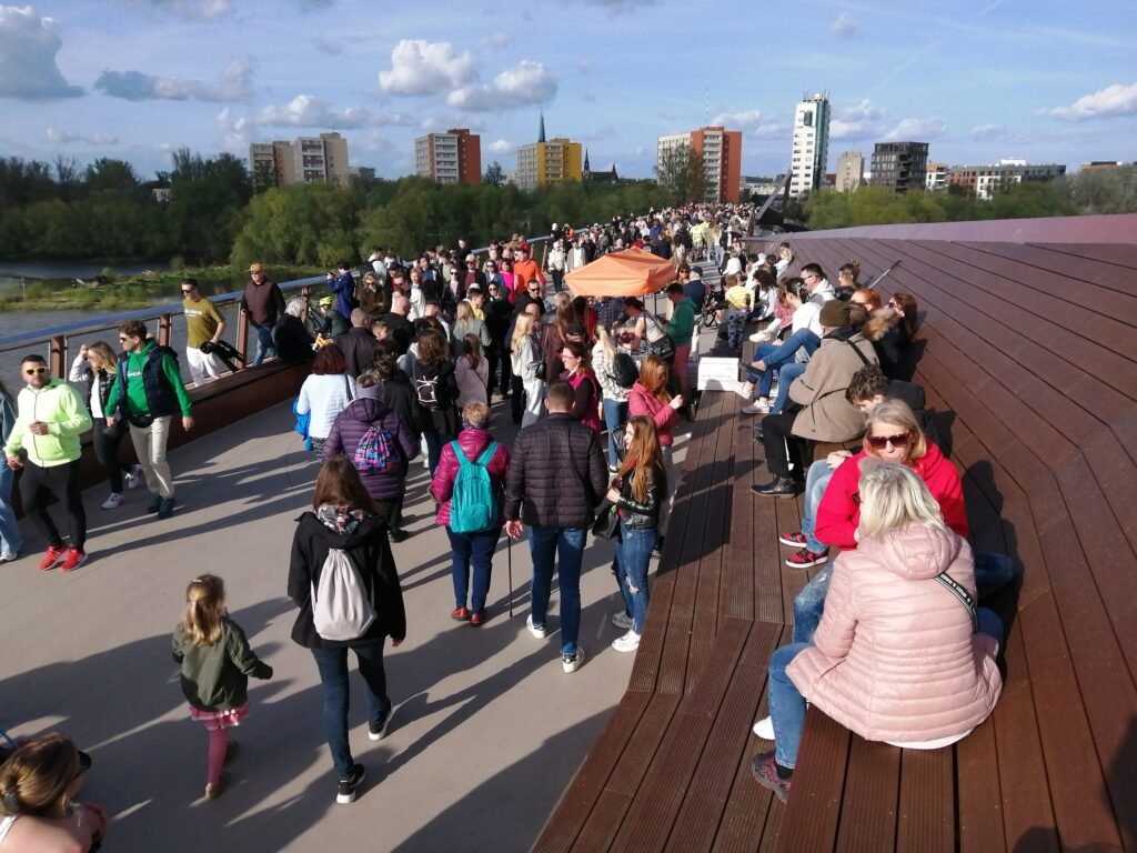 Pedestrians using Warsaw’s Vistula pedestrian and cycling bridge toward Praga